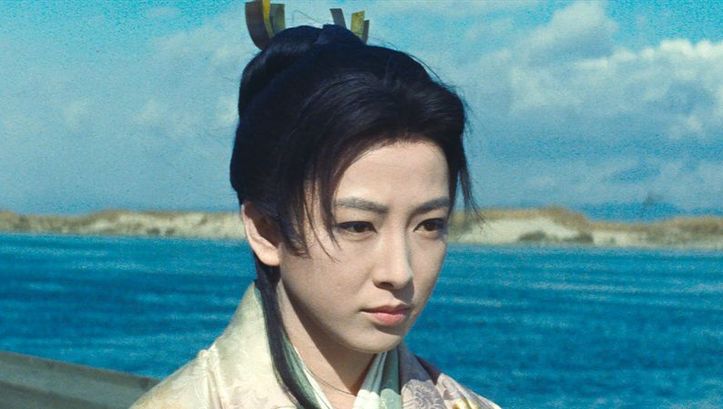 Film still from OGIN-SAMA: A woman in a traditional Japanese kimono in front of a body of water.