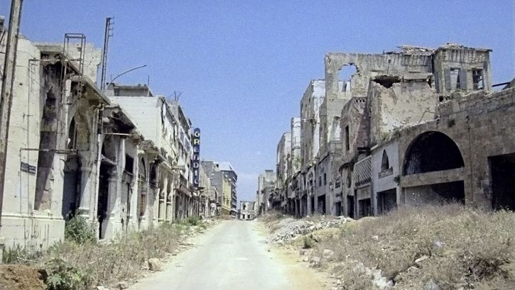 Still from the film "Beirut al lika (Beirut the Encounter)" by Borhane Alaouié. An empty street that shows damage from conflict.