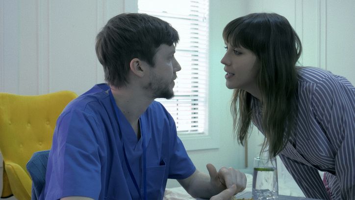 Film still from ENDURANCE: A man and a woman talking.