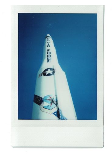 Polaroid of a tall missile bearing the words “US Air Force”, seen from below.