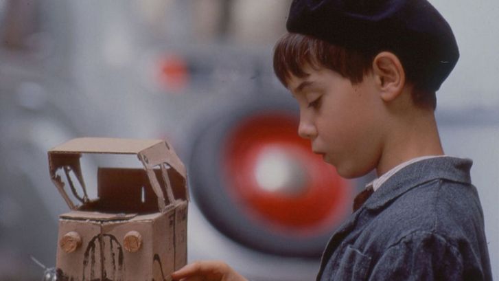 Film still from JACQUOT DE NANTES. A little boy with a toy car made of cardboard.