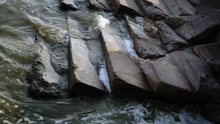 Film still from VOR ZEIT. Semi-destroyed stairs washed by water.
