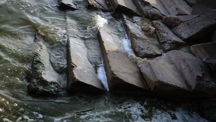 Film still from VOR ZEIT. Semi-destroyed stairs washed by water.