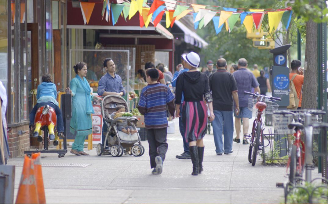 Film still from IN JACKSON HEIGHTS. People on the street in New York City