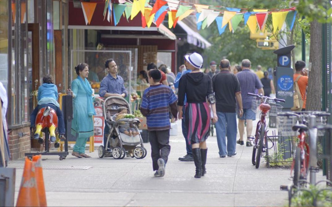 Film still from IN JACKSON HEIGHTS. People on the street in New York City
