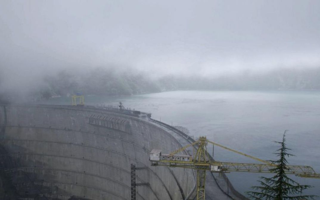 Filmstill aus WATER HAS NO BORDERS. Aufnahme eines riesigen Staudamms im Nebel.