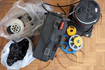 Photo of the 8mm film used for the film "Majmouan" (Subtotals) by Mohammadreza Farzad. You can see the used technology lying on the floor.