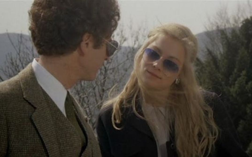 Film still from BAD TIMING: A woman and a man are standing outside, looking at each other. They