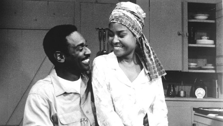 Film still from NOTHING BUT A MAN: A man and a woman sit at the kitchen table and smile at each other.