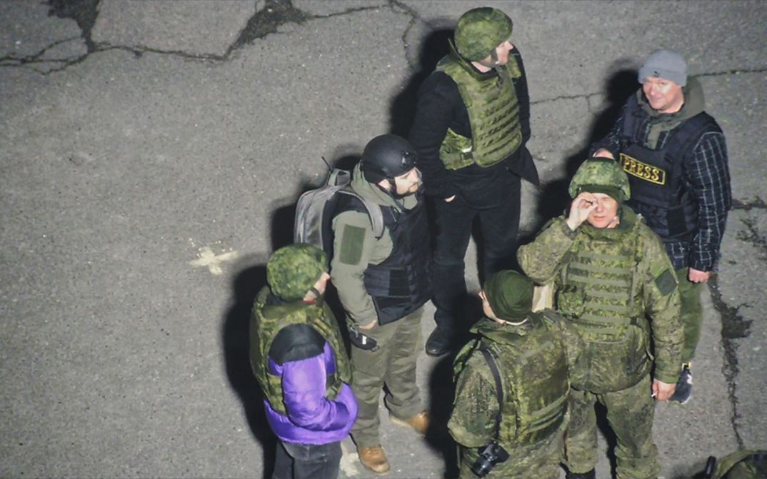 Film still from Oleksiy Radynski’s film “Special Operation”. A group of Russian soldiers filmed in the parking lot of Ukraine
